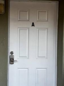a white door with a letter a on it at Comfy 2 bedroom apartment in Port Richey