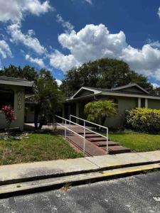 a house with a staircase in front of a house at Comfy 2 bedroom apartment in Port Richey