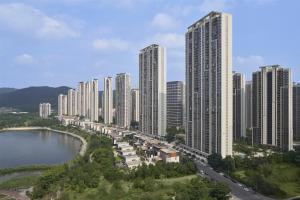 an aerial view of a city with tall buildings at The Meixi Lake, Changsha Marriott Executive Apartments in Changsha