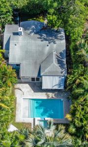 an aerial view of a house with a swimming pool at Art Deco Villa Heated Pool Jacuzzi Very Private house on a quite street close to Design District 10 minutes from the Beach - in Miami