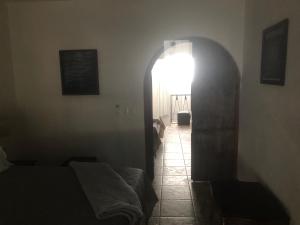 a room with a hallway with a mirror and a light at Maru's House in Guadalajara