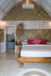 a bedroom with a large bed with red pillows at Aranka Tempasan in Sangyang