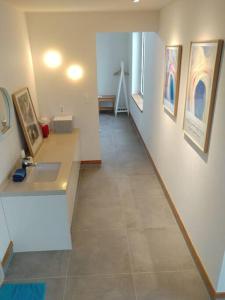 a hallway in a building with paintings on the wall at A shell in Jeju in Seogwipo +65 photos
