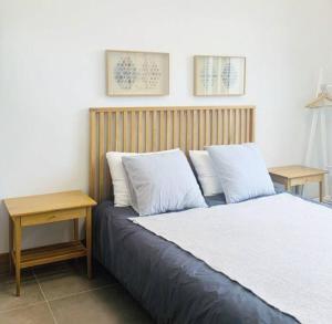a bedroom with a bed with two pillows and a table at A shell in Jeju in Seogwipo