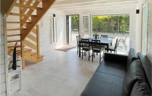 a living room with a couch and a table and chairs at Awesome Home In Grzybowo With Kitchen in Grzybowo