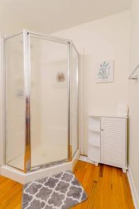 a bathroom with a shower and a rug at Saratoga Serenity: Charming Rental Nearby Downtown in Saratoga Springs