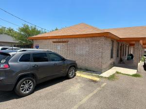 a car parked in a parking lot in front of a house at Chic & Cozy 2 bedroom - 1 bathroom - RATED BEST in Eagle Pass