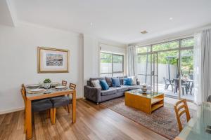 a living room with a couch and a table at CityStyle Apartments in Canberra