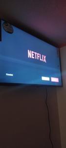 a sign that reads netflix hanging on a wall at Alójate con Estefany in Latacunga
