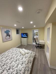 a bedroom with a bed and a desk and a computer at Beautiful Unit in Nepean Ottawa in Ottawa