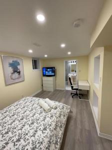 a bedroom with a bed and a desk and a computer at Beautiful Unit in Nepean Ottawa in Ottawa