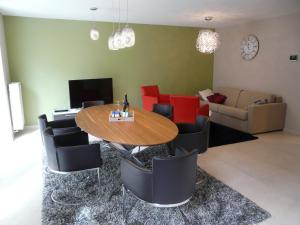 a living room with a table and chairs and a couch at ABC Apartment Langestraat in Blankenberge