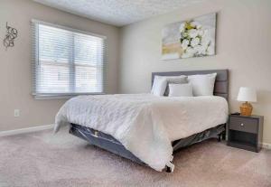 a bedroom with a large bed and a window at Peace and Games with Class in Stone Mountain