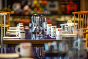 a table with cups and mugs on it at W Suzhou - Jinji Lake in Suzhou