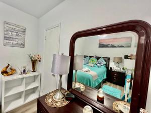 a bedroom with a bed and a mirror on a dresser at Relax 521 in Miami