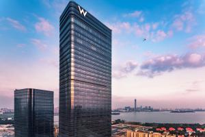 a tall building with a m logo on top of it at W Suzhou - Jinji Lake in Suzhou