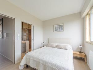 a white bedroom with a bed and a window at Appartement La Rochelle, 2 pièces, 2 personnes - FR-1-535-47 in La Rochelle
