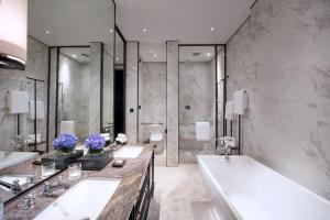 a bathroom with two sinks and a tub and a shower at Sofitel Foshan Shunde in Shunde