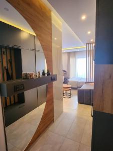 a living room with a large mirror and a bedroom at Mon réve Nlux79 in Kopaonik