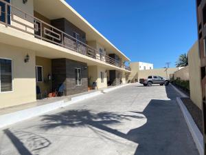 a car parked in a parking lot next to a building at Ancla Suite 2 - 2 Bedroom Urban Hotel in Puerto Peñasco