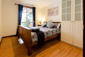a bedroom with a bed and a window at Camellia Cottage - Country Rustic Charm Close to Forest and Town in Margaret River Town