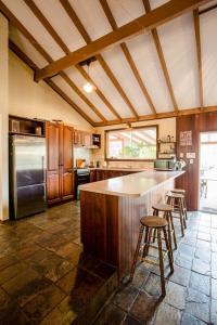 a kitchen with a counter and stools in it at Camellia Cottage - Country Rustic Charm Close to Forest and Town in Margaret River Town