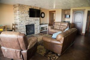 a living room with leather furniture and a fireplace at The Maple Retreat in Garden City