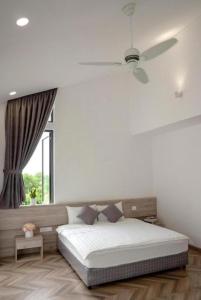 a white bedroom with a bed and a window at Nam Casa Sân Golf Tam Đảo Venuestay in Tam Ðảo