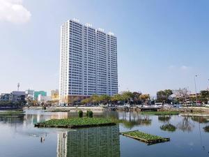 a large building in the middle of a body of water at ChouChou Apartment in Danang