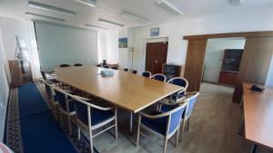 a conference room with a large wooden table and chairs at U vodohospodárov in Banská Štiavnica