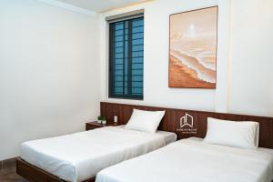 Giường trong phòng chung tại PLEIKU HIGHLANDS BOUTIQUE HOTEL