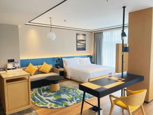 a hotel room with a bed and a desk at Hilton Garden Inn Huzhou Anji Phoenix Mountain in Anji +29 photos