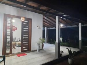 a living room with a wooden door and a couch at Fully Furnished house for rent in Gampaha/Ja-ela (Colombo) in Gampaha