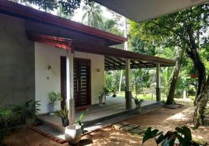 a house with a porch with plants in front of it at Fully Furnished house for rent in Gampaha/Ja-ela (Colombo) in Gampaha