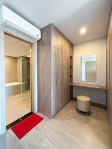 a bathroom with a shower and a red rug at Homestay the Sóng in Vung Tau