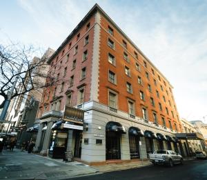 a large brick building on the corner of a street at The Chancellor on Currie in Adelaide