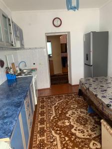 a kitchen with a counter top and a refrigerator at Guest House in Cholpon-Ata