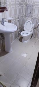 a bathroom with a toilet and a sink at Adex Cool Apartment in Abu Dhabi