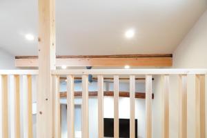 a white crib with wooden railings in a room at Rikka Fukiya in Takayama