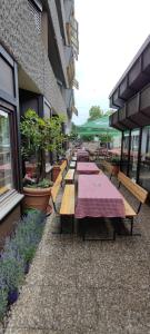 eine Reihe von Picknicktischen vor einem Gebäude in der Unterkunft Hotel Spahr in Stuttgart