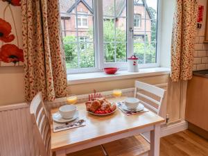 a table with a bowl of fruit and a window at Cupid's Cottage in Bessingby +27 photos