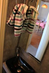 a bathroom with a black sink and a mirror at Mistra Estates Villa The Vine in Pikouliánika +27 photos