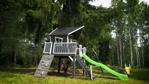 a playground with a slide and a play structure at Jurty w Lesie KotfaLas in Skarżysko-Kamienna