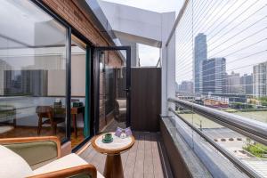 a balcony with a view of a city skyline at Nostalgia S Hotel Shanghai Railway Station in Shanghai