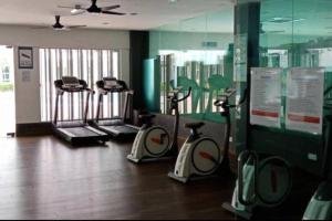 a gym with three exercise bikes in a room at Kid Slide Family Apartment with 2 Bedroom + 2 Bath in Masai