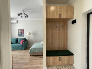 a bedroom with a bed and a room with a closet at Город Ботанический in Taldykolʼ