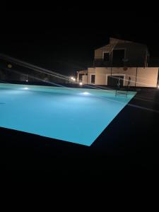 a swimming pool at night with blue illumination at Villa Simo in Altavilla Milicia