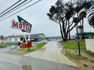 a motel sign on the side of a road at Wiebe Motel in Hollister