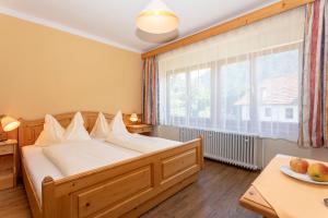 a bedroom with a bed and a large window at Der Graggober in Oberwölz Stadt