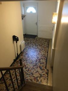 a hallway with a door and a tile floor at Villa Elda in Saint-Jean-dʼAngély